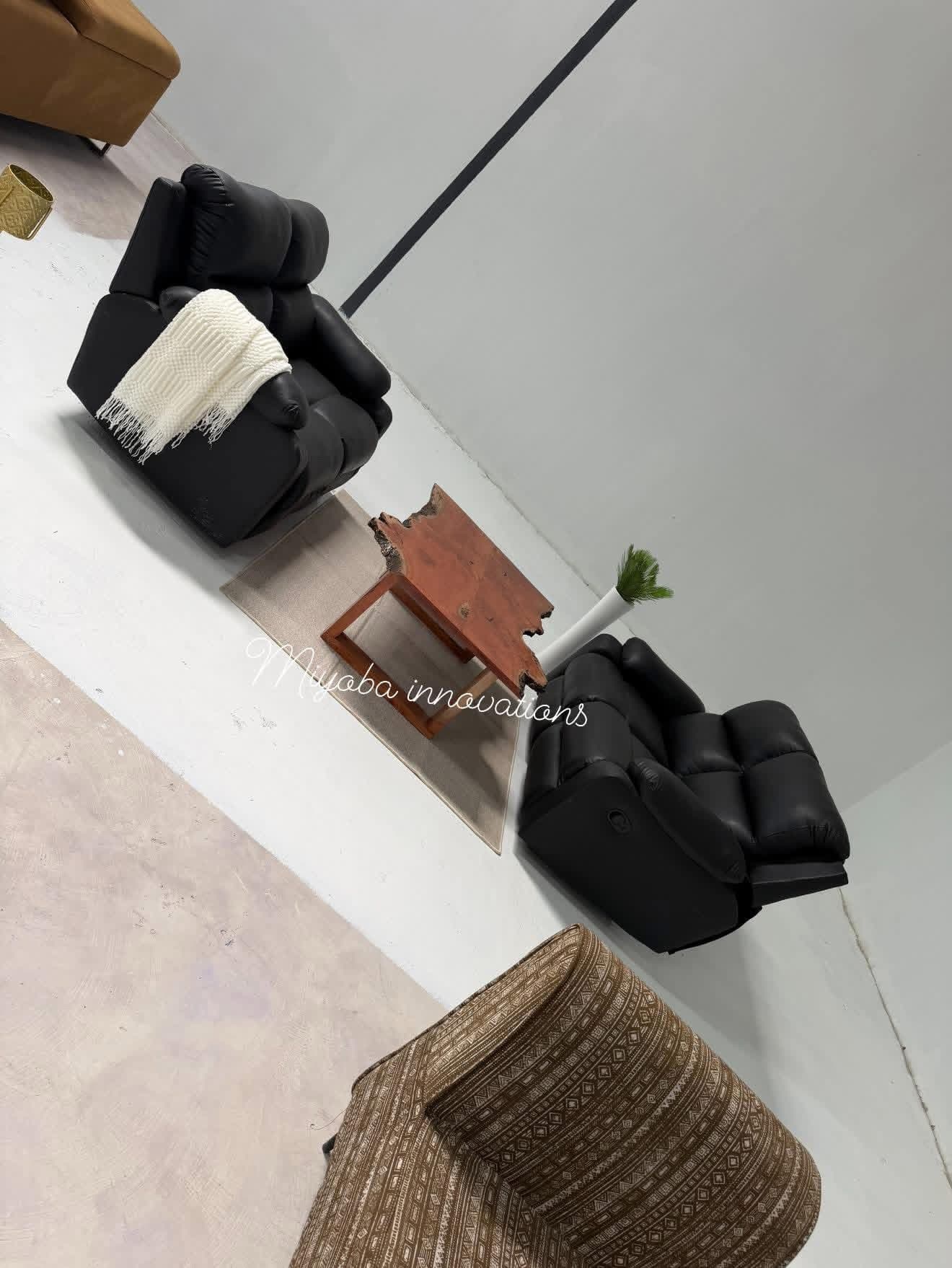 Black leather reclining sofa set with live-edge wooden coffee table